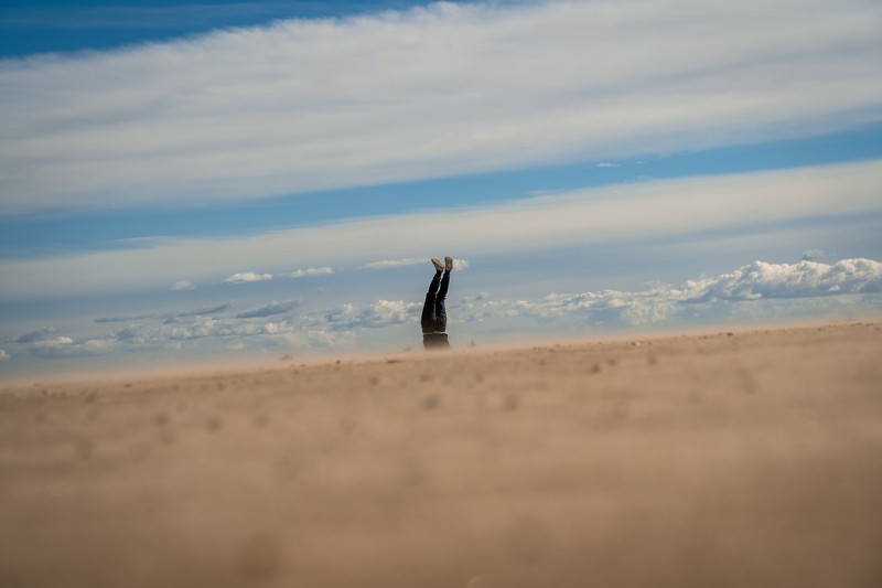 Man doing a handstand on the beach in Valencia