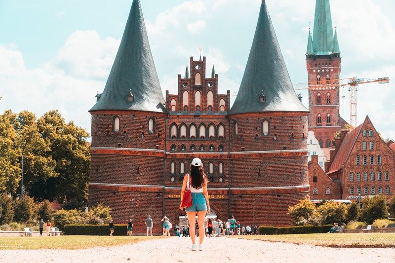 Lübeck sightseeing day trip: Woman standing in front of Holstentor