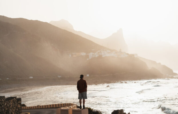 Tenerife Vacation: A man stands on the coast of Tenerife at the Mirador de Benijo, enjoying the sunset
